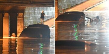 Gruaja shpëton një burrë nga makina që po mbytej pas reshjeve të mëdha të shiut